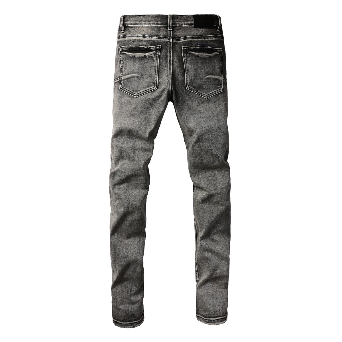 Jeans de mezclilla en tono gris lavado oscuro, acabado desgastado estilo vintage.