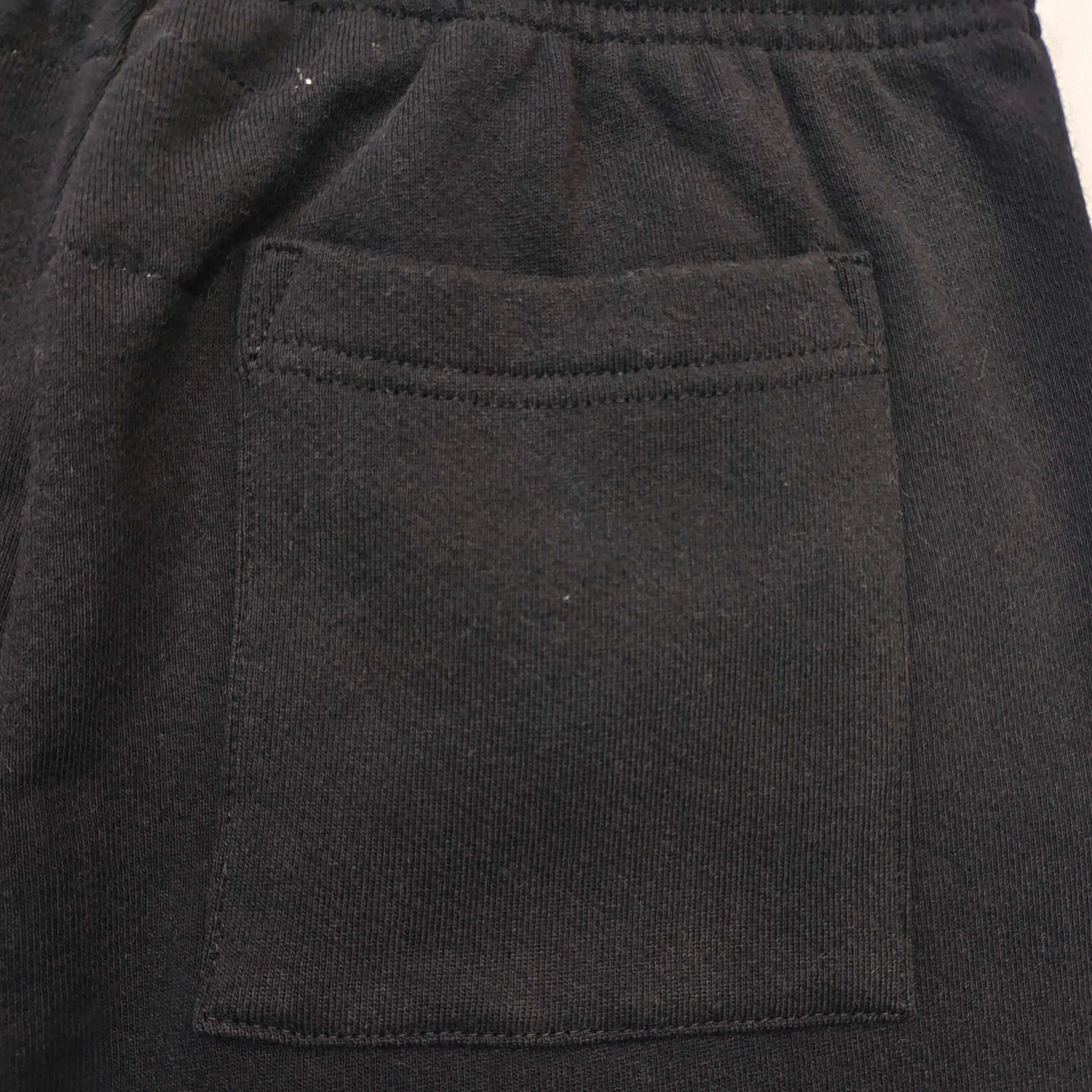 Pantalones Sp5der – Logo Curvo Gris