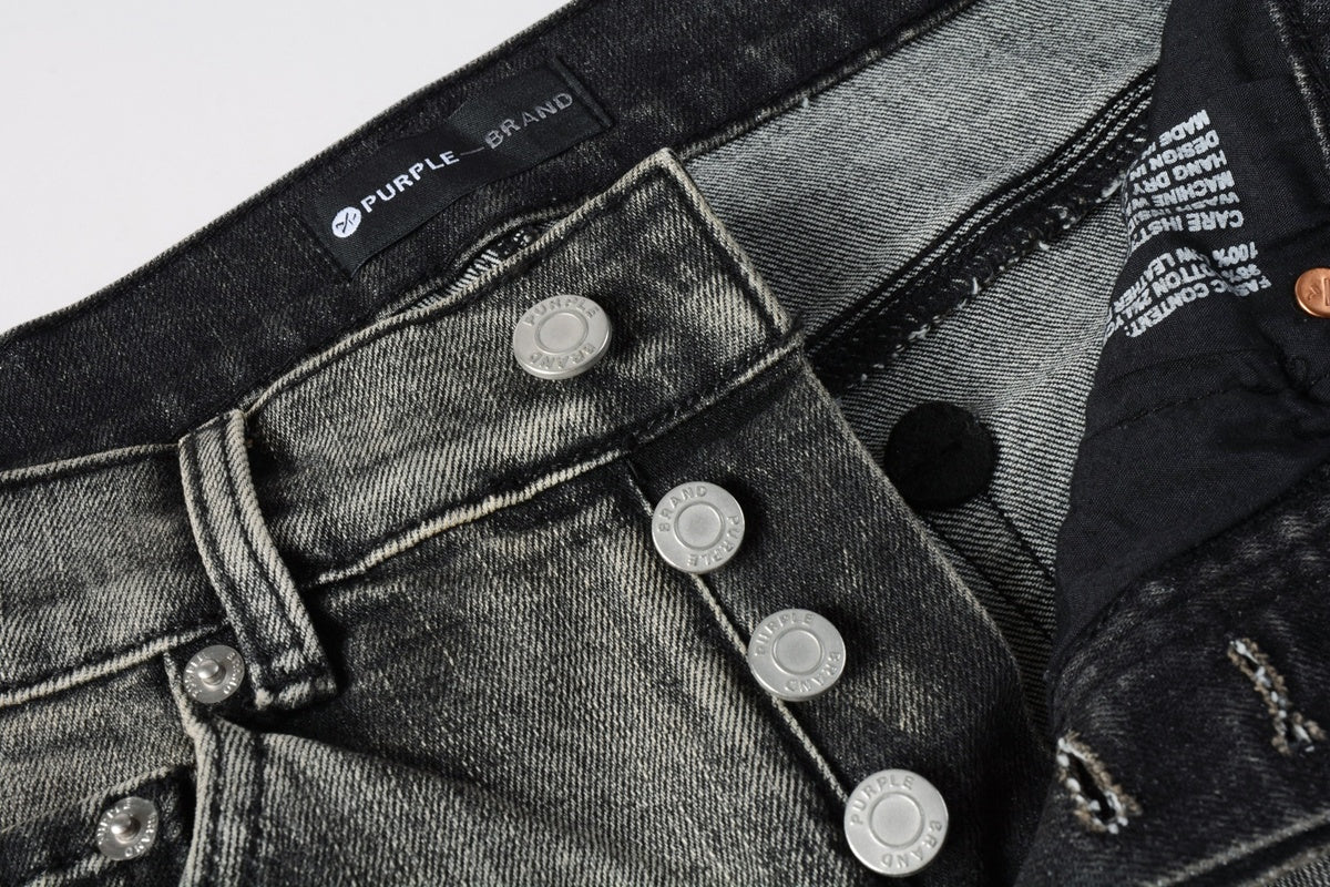 Jeans de mezclilla en tono gris lavado oscuro, acabado desgastado estilo vintage.